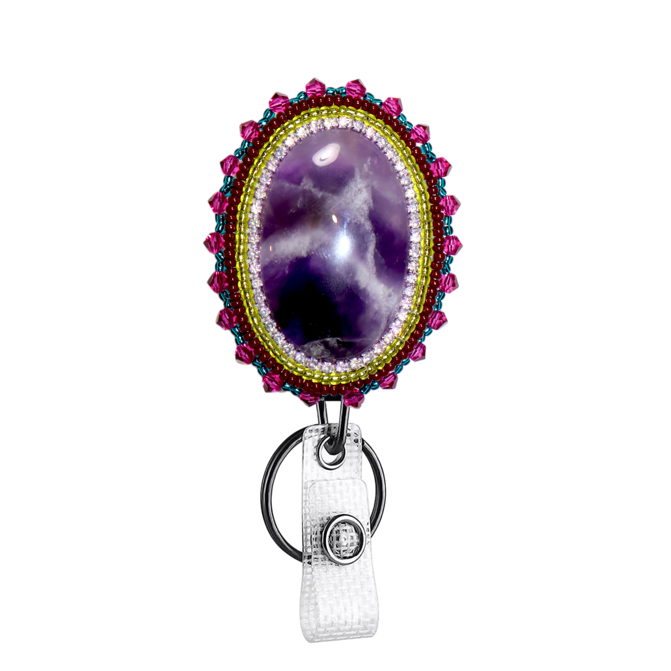 A beaded oval badge reel featuring a purple amethyst cabochon in the center, surrounded by a gold beaded border and pink and blue bead accents, with a white textured strap and silver metal ring.