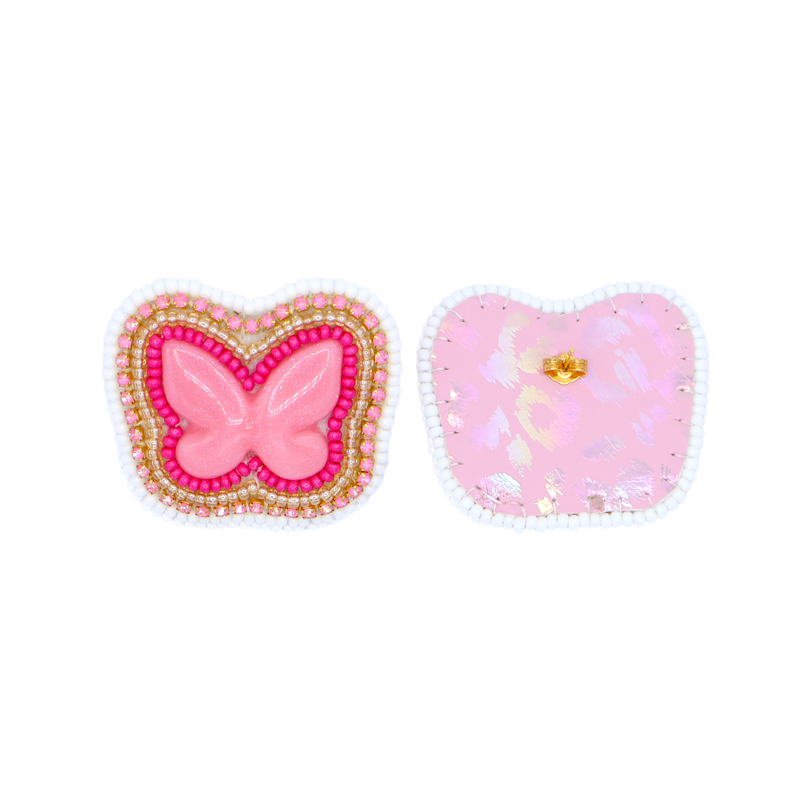 Two decorative embellishments on a white background: a butterfly-shaped earring with pink center and gold/red beaded border, and a heart-shaped patch with pink glitter and a small gold butterfly detail.