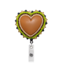 A heart-shaped retractable badge reel featuring a tan leather center surrounded by a beaded border of lime green, white, and black beads, with a silver metal clip below.