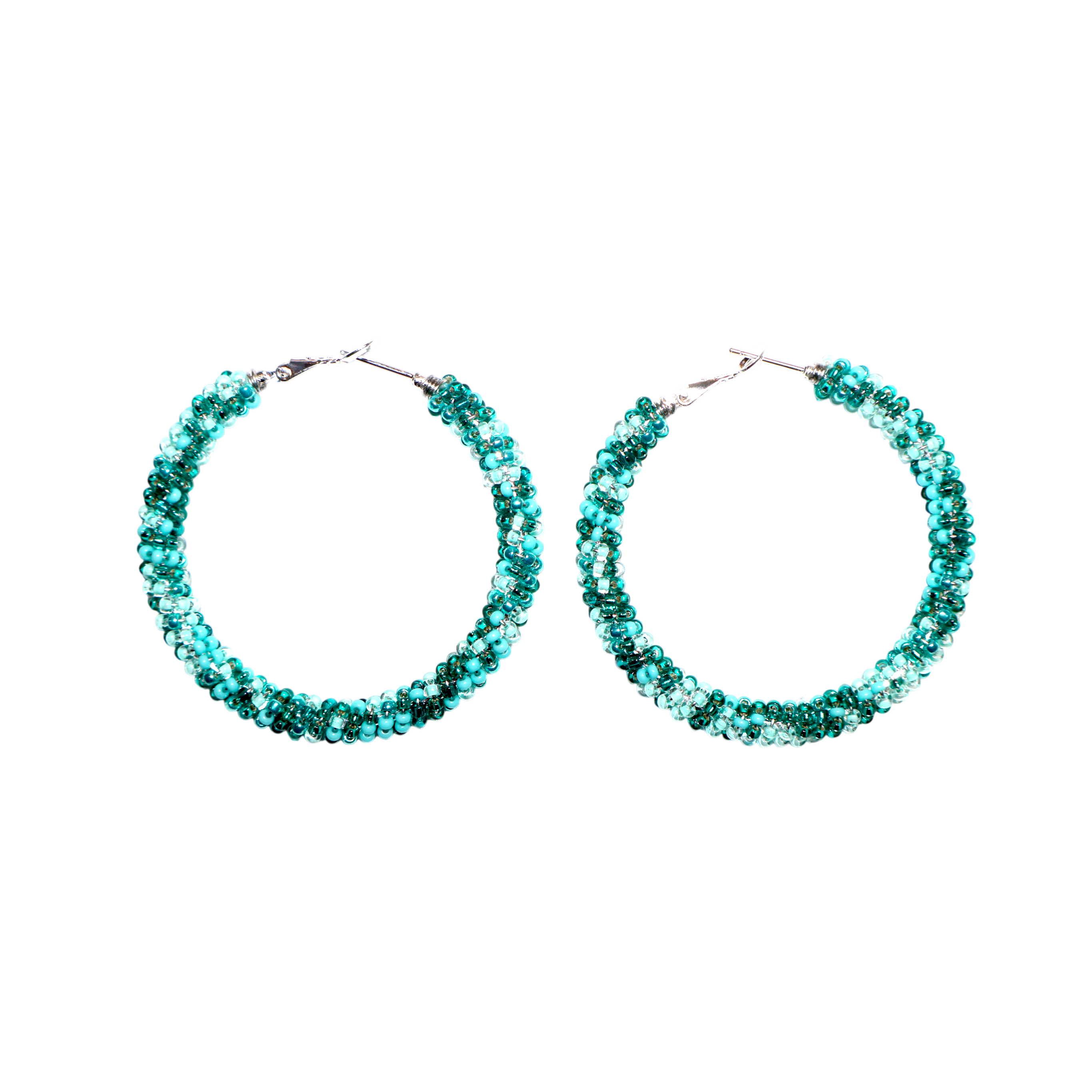 A pair of large hoop earrings covered in sparkling teal-blue rhinestones, set against a solid white background.