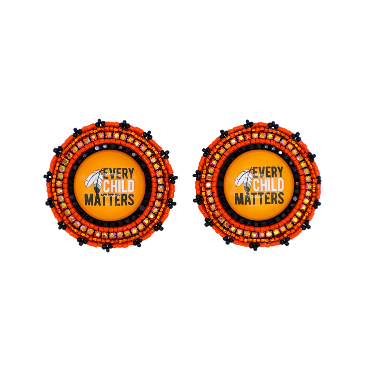 Two circular patchwork earrings on a plain white background. Each earring features a central yellow circle with a black and white bird logo and the text 'EVERY CHILD MATTERS' in black.