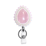 A pink teardrop-shaped Rose Quartz pendant with a scalloped white and pearl border, attached to a silver key ring and white textured strap, shown on a plain white background.