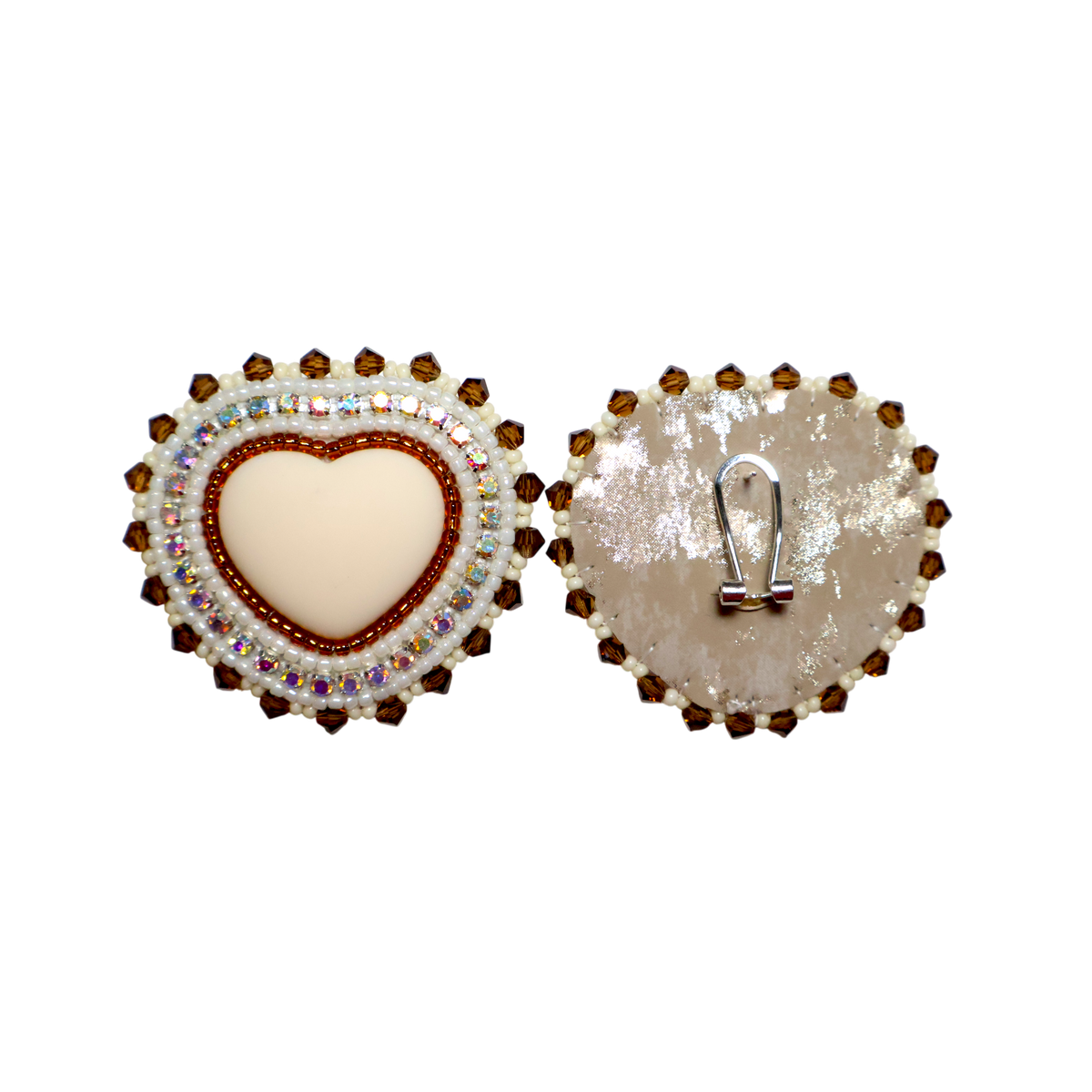 A pair of heart-shaped earring shown from the front and back on a plain white background. The front features a cream-colored center heart bordered by red and iridescent rhinestones, surrounded by a halo of brown rhinestones.