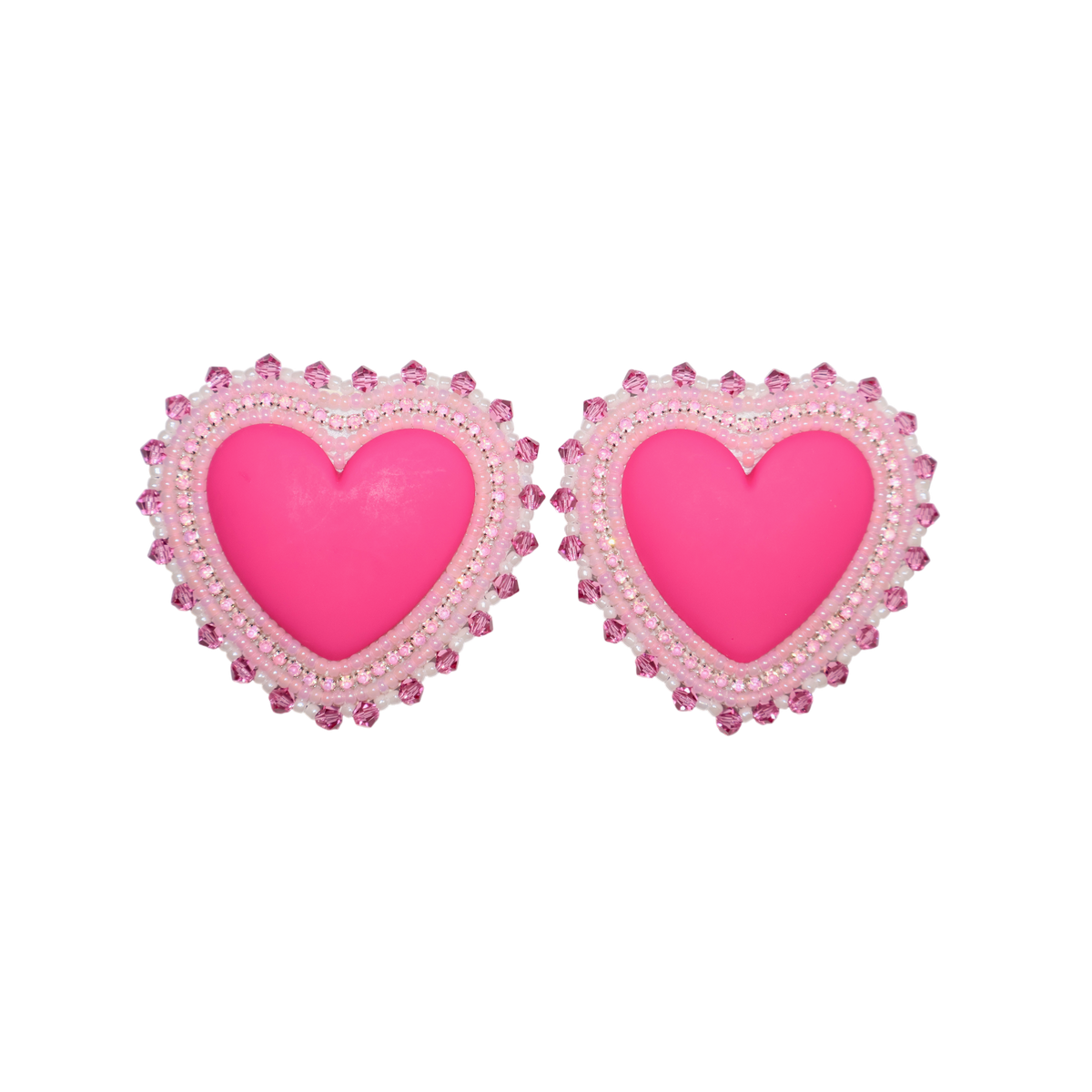A pair of heart-shaped stud earrings with bright pink centers and white beaded borders, shown on a plain white background.